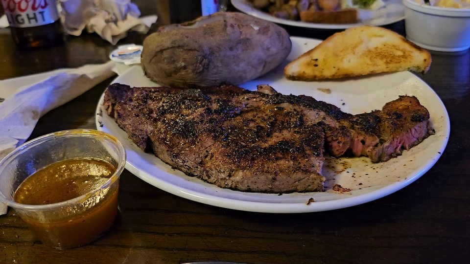 Smoky barbecue plates on a casual restaurant table.
