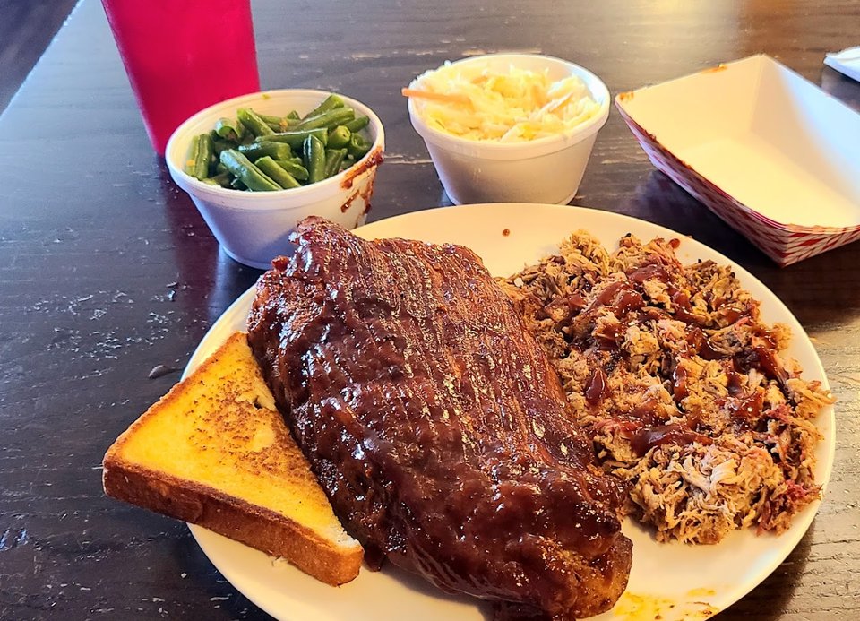 Shared plates beside drinks and a bar counter.